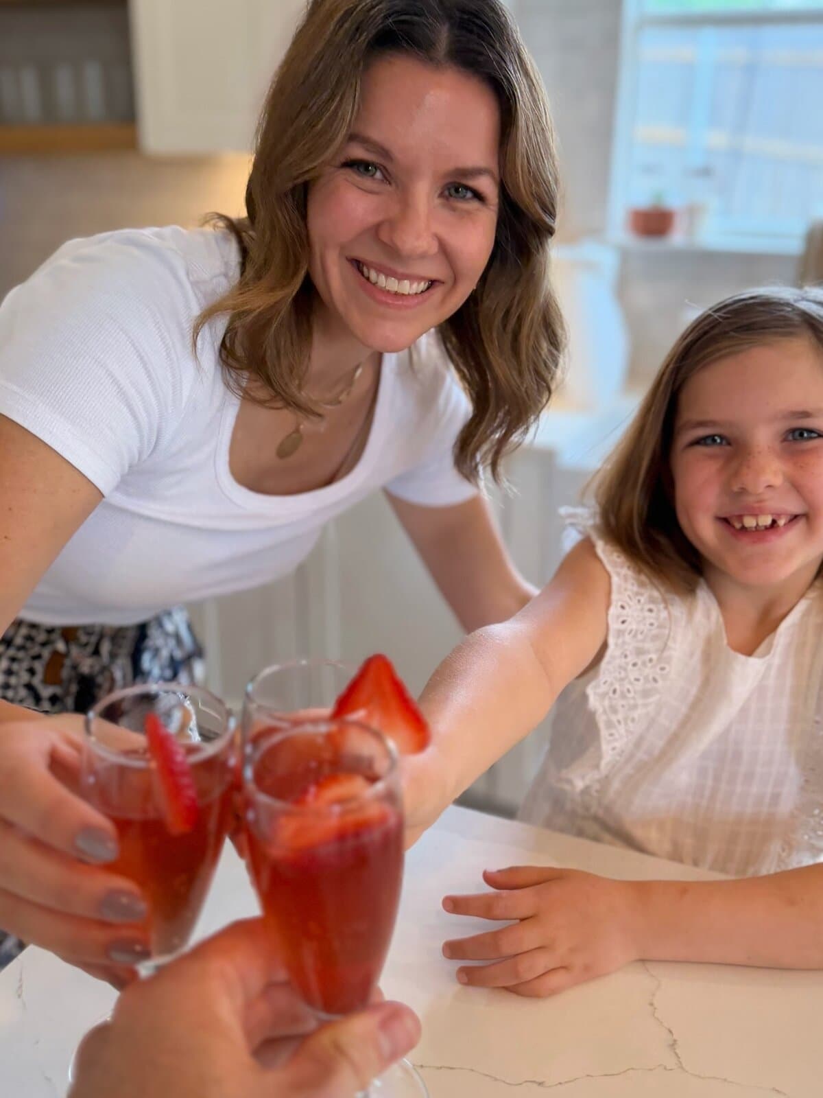 Mom + 1: a mom and her daughter sharing strawberry mimosa mocktails