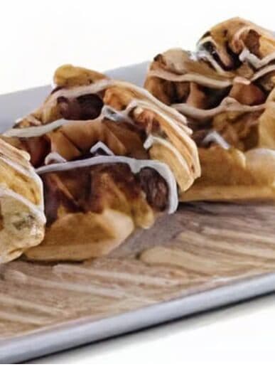 Nanna's waffled cinnamon rolls topped with sweet icing on a platter